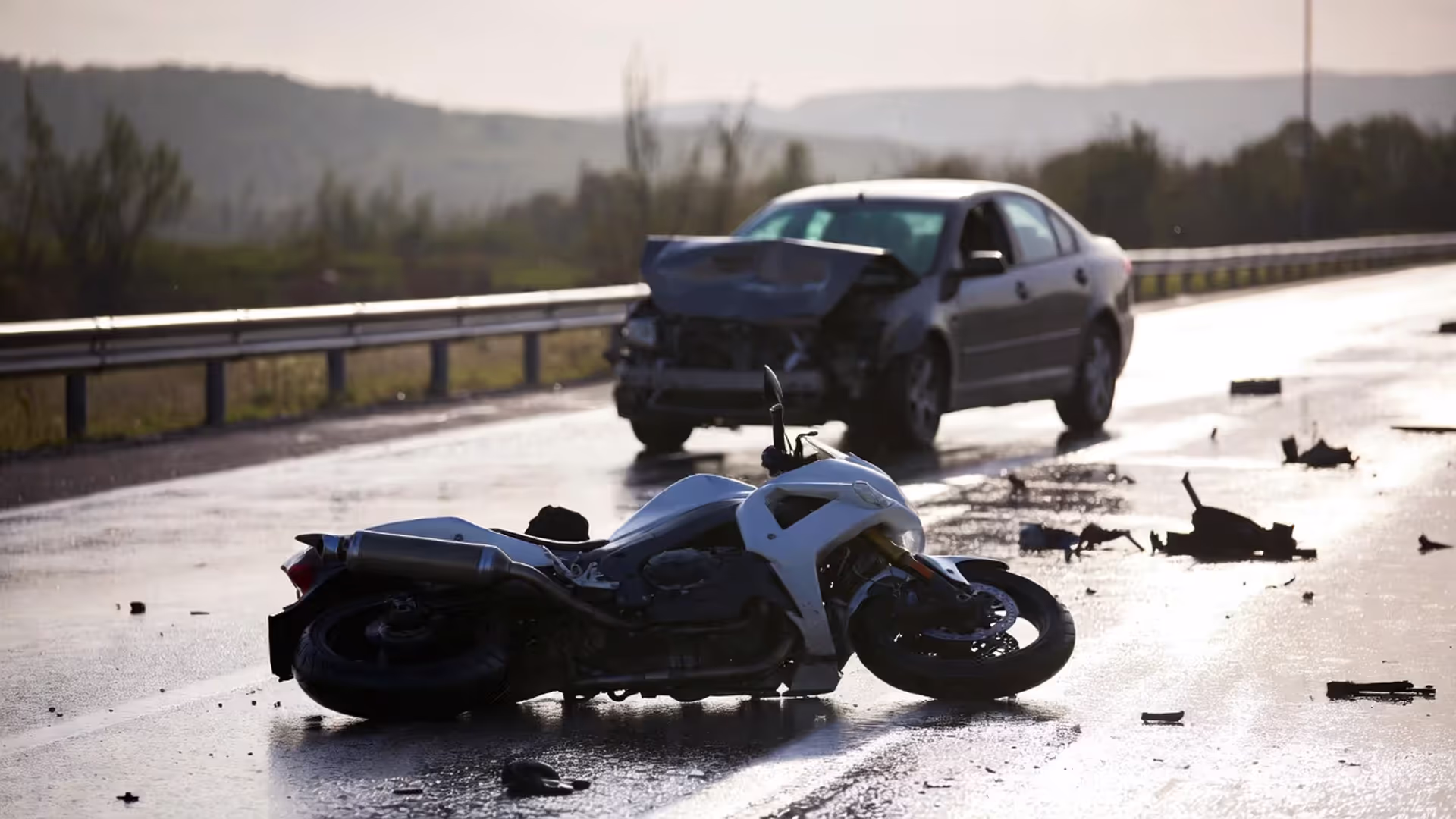 Motorcycle rider in leather gear sitting in wheelchair at lawyer office desk reviewing structured settlement financial documents and payment schedules